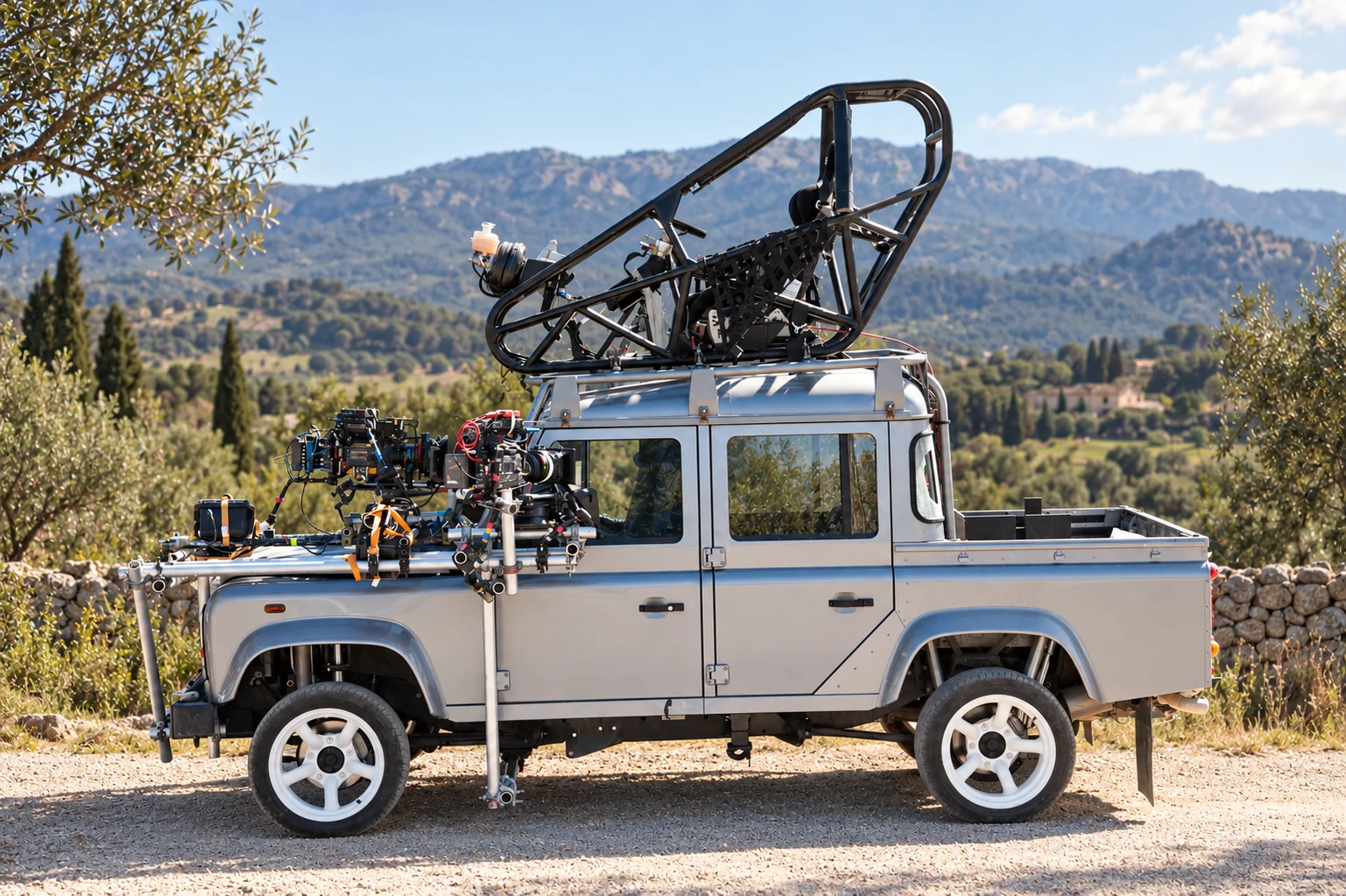 Defender Double Cab Pick Up with film cameras and elevated driving rig
