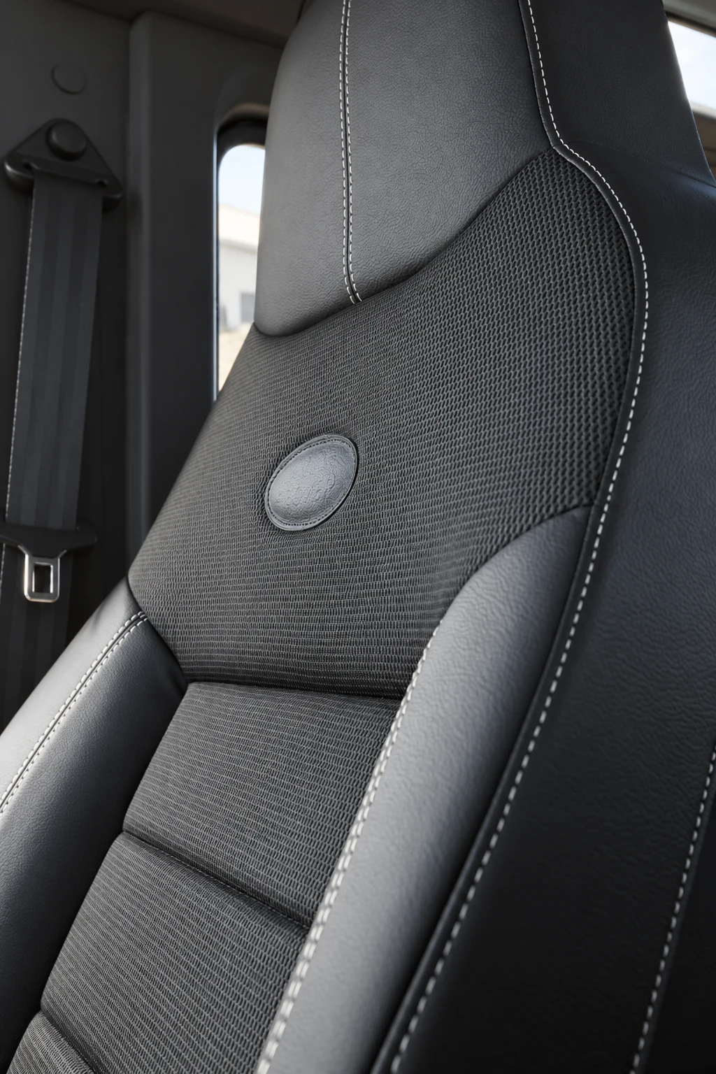 Seat upholstery, stitching and integrated head restraint