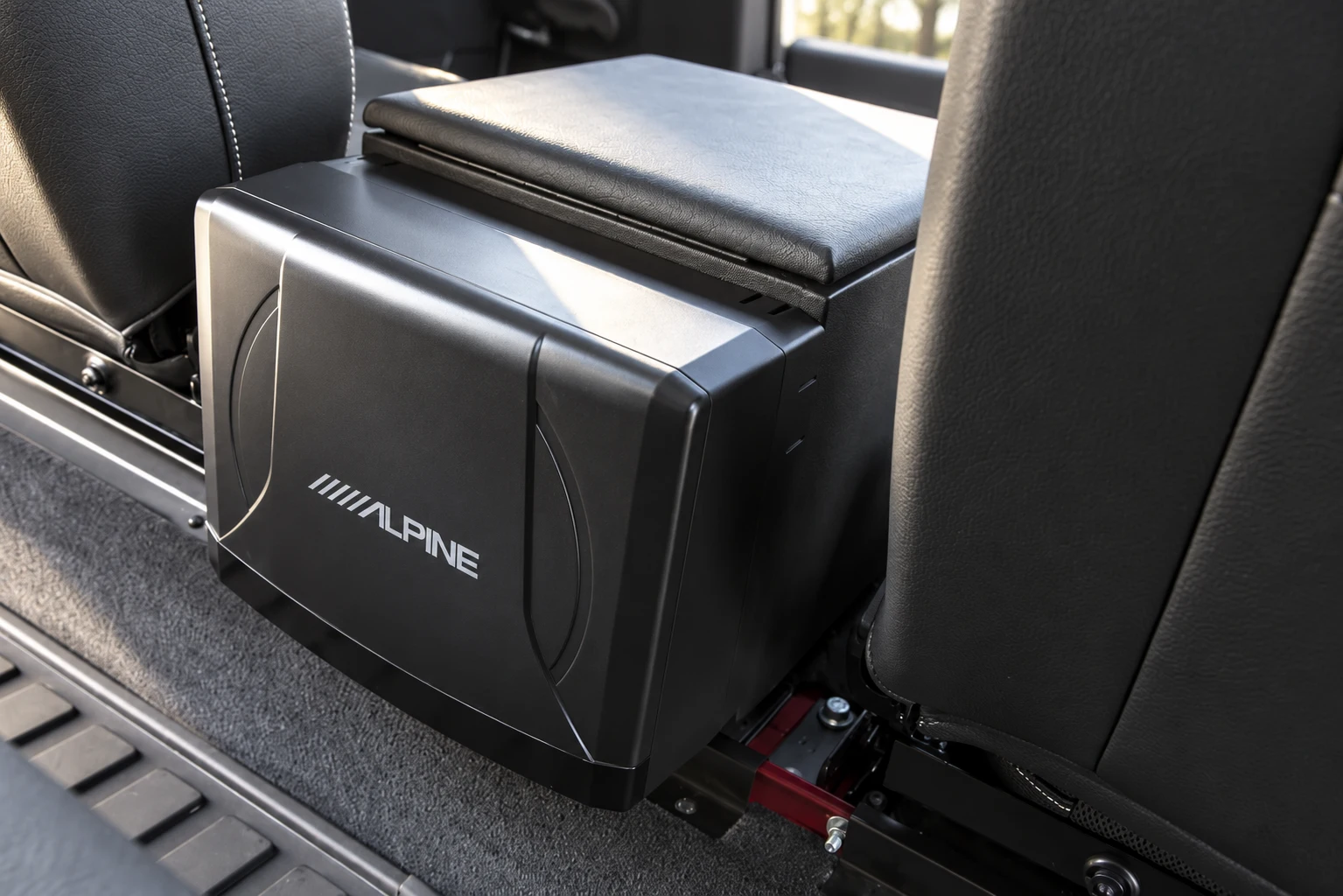 Low-profile Alpine unit behind the centre storage box