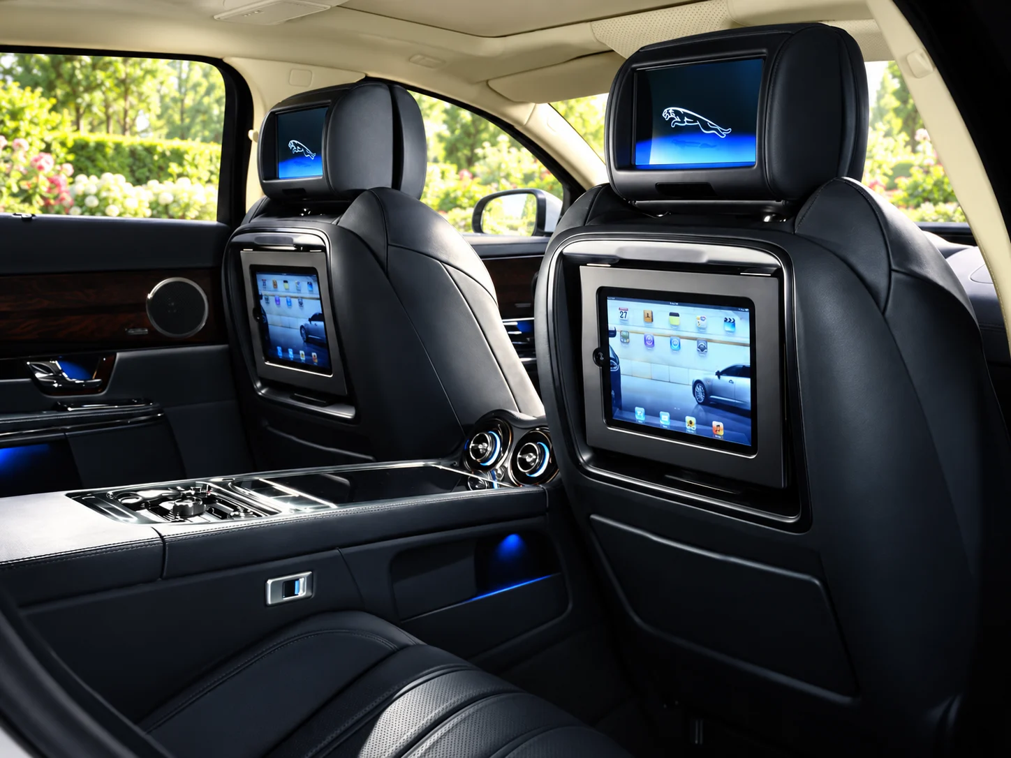 Headrest entertainment screens above the separate iPad docks